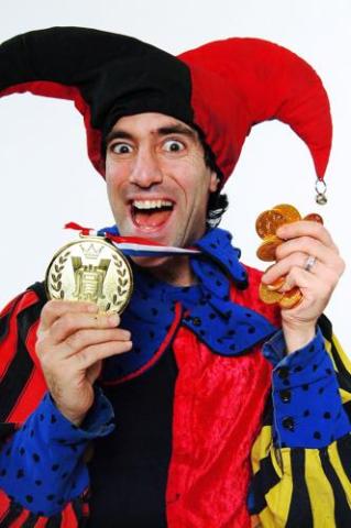 A smiling man in a jester's costume.