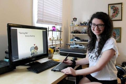 An artist at a desk with a computer monitor.