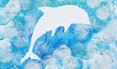 A white dolphin silhouette on a blue painted canvas