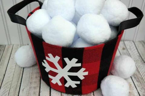 A bucket full of fabric snowballs.