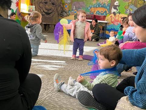 Toddlers play with toys in the Program Room.