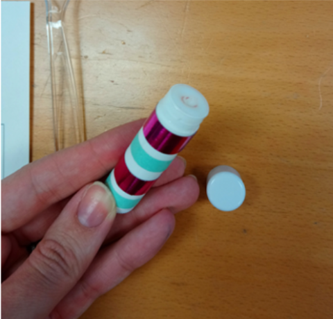 A colorful tube of homemade lip balm.