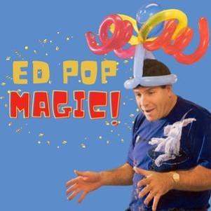 A man wears a big hat made out of balloons.