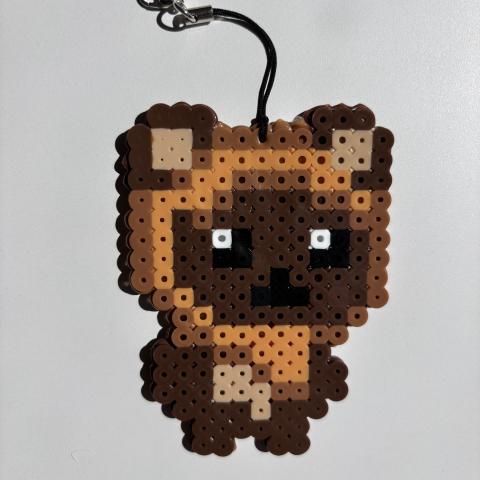 A cute creature made out of Perler beads.