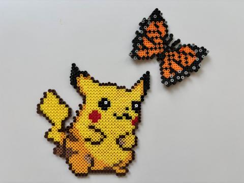 A Perler bead Pokemon character with a Perler bead butterfly