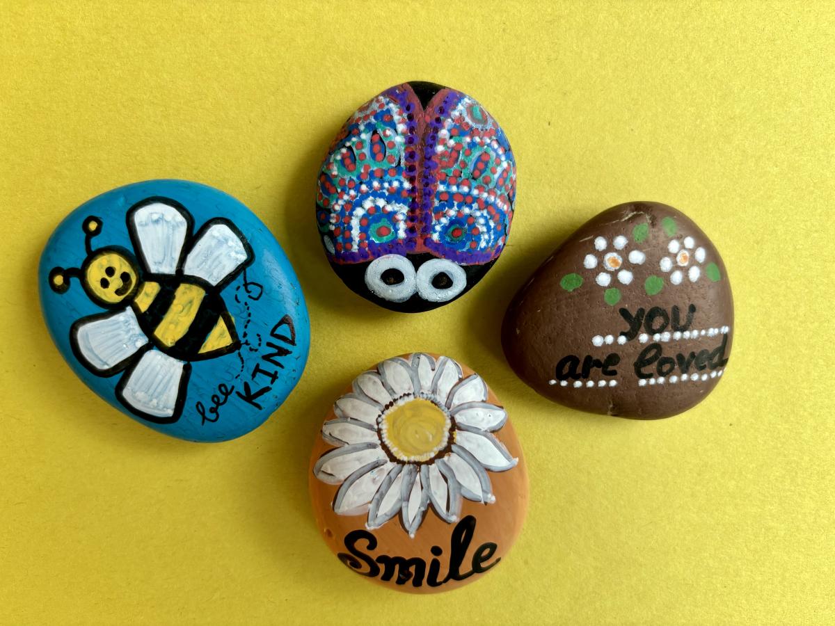 Smooth stones painted in adorable designs.