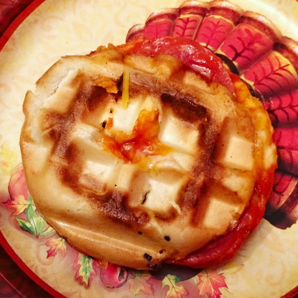 A pizza cooked in a waffle maker.